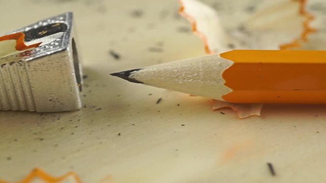 Macro dolly shot of sharpener and sharp pencil with eraser