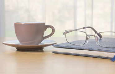 Glasses and book on the desk