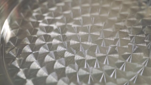 Macro video of moving highlights on milled steel