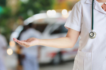female doctor with ambulance responding to emergency call