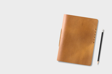 Brown Leather notebooks with pencil on gray table background