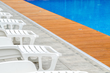 clean swimming pool and empty resting chair