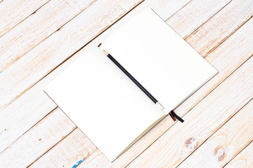 Blank open notebook with pencil on wood table,Business template