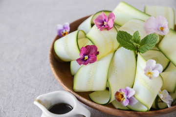 Zucchini salad with edible flowers, summer vegan salad