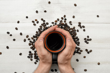 Close-up hands of man holding a cup coffee