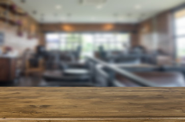 Selected focus empty brown wooden table and Coffee shop blur bac
