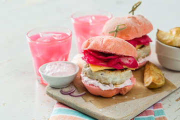 Pink chicken grill burger on wood background
