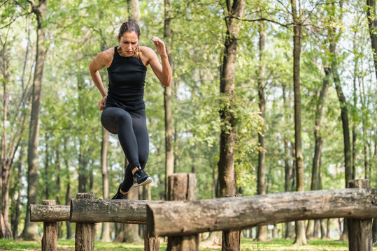 Running across wooden hurdles on a fitness trail