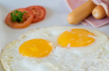Fried eggs with bacon and hotdog, traditional breakfast