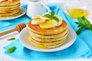 Pancake with banana, covered with honey or maple syrup