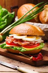 Prosciutto ham sandwich with egg and vegetables.