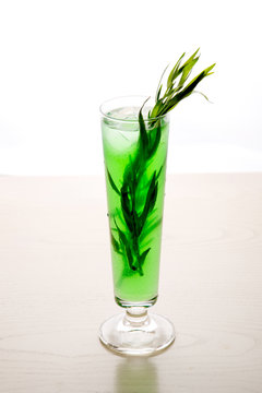 a refreshing cocktail with leaves of tarragon and ice