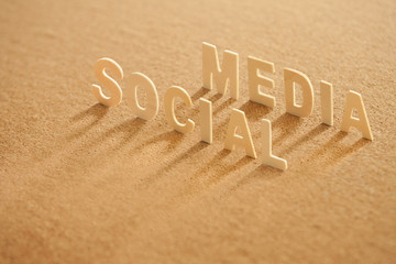 social media word made of wood with shadow on compressed board