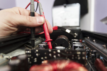 Tech tests electronic equipment in service center