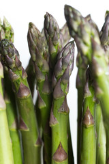 Bunch of asparagus on a table. Uncooked pile raw for organic, vegetarian cuisine, delicious fresh, healthy ingredient. Closeup and copy space.