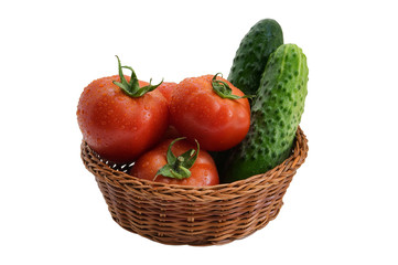 Fresh cucumbers and tomatoes in a wicker basket on a white background isolated