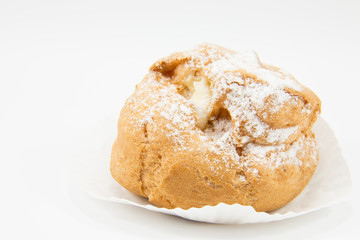 Close up brown cream choux on white paper