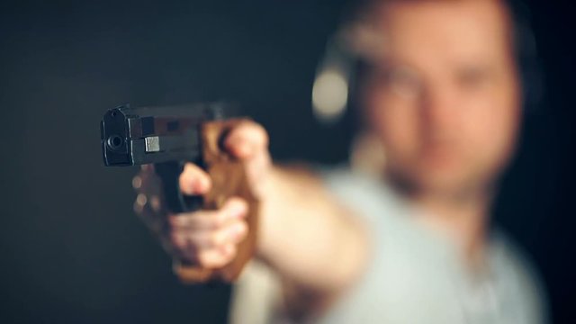 Man shooting with gun at a target