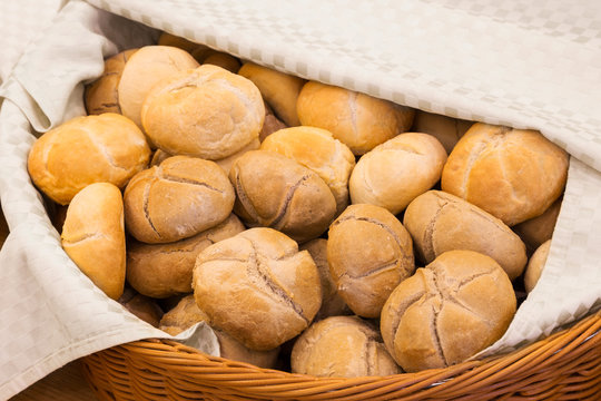 Wicker basket lined with a cloth filled with buns