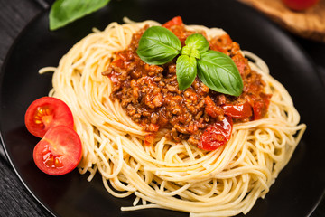 Spaghetti bolognese on dark background
