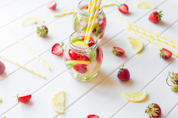 Strawberry lemonade with fresh mint on white wooden background