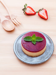 Strawberry cheesecake with fresh mint leaves on wooden backgroun