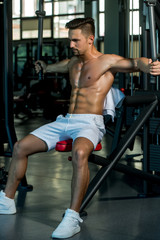 Fototapeta na wymiar muscular man training in gym
