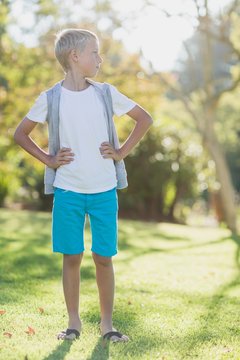 Boy standing with hand on hip in park