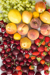 Naklejka na ściany i meble Fresh mixed fruits, berries background.Healthy eating.Love fruit, diet.