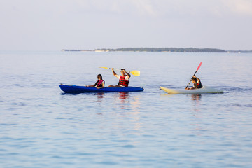 Fototapeta na wymiar happy family with a sea kayak