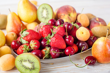 Naklejka na ściany i meble Fresh mixed fruits, berries on plate. Summer fruit, berry.