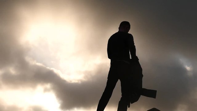 funny Silhouette of man fast cloth away oneself sky background 