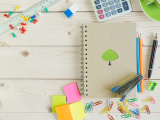 Colorful stationery and book on the wooden table
