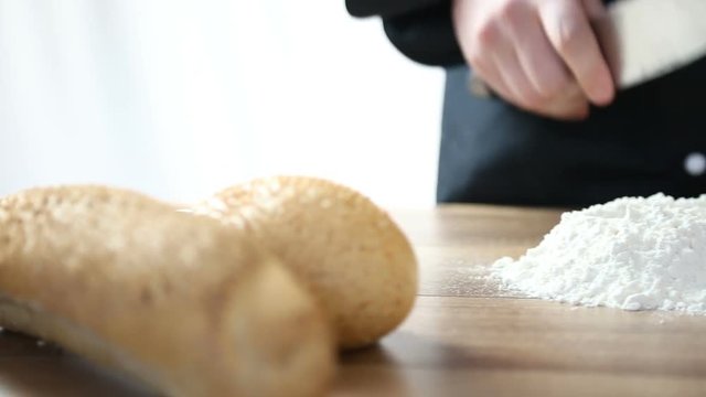 Chef breaks an egg and knead the dough