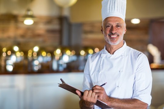 Portrait of chef holding a clipboard