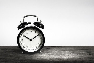 Alarm clock on wood isolated on white background.