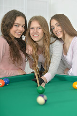 girls with cue playing billiard