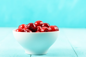 White Bowl Of Fresh Red Cherries On Turquoise Background
