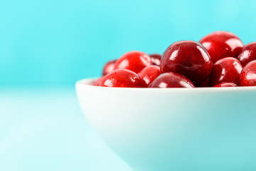 White Bowl Of Fresh Red Cherries On Turquoise Background