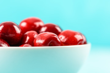 White Bowl Of Fresh Red Cherries On Turquoise Background