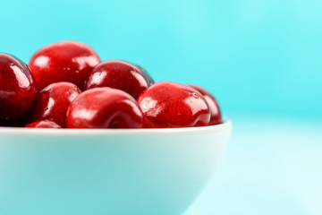 White Bowl Of Fresh Red Cherries On Turquoise Background