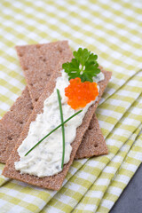 Crispbread with soft cheese with herbs and bacon.