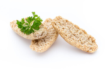 Dry flat bread crisps with herbs on a white background.