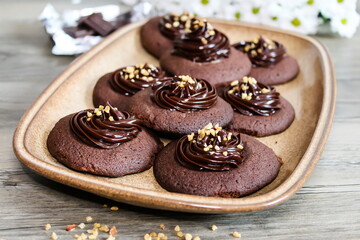 Chocolate cookies with nuts and ganache cream