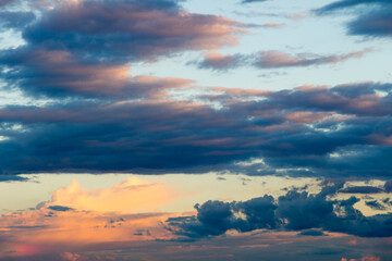 Beautiful cloudy sky with sun rays. Cloudy abstract background. Sunset light.