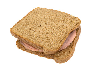 Mortadella sandwich on wheat bread isolated on a white background.