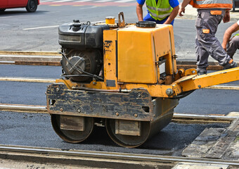 Road construction with steam roller