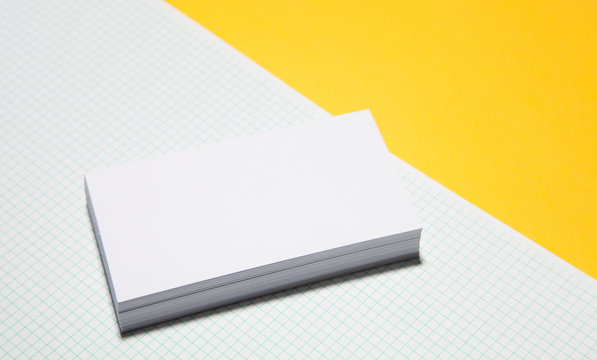 Empty business cards on yellow background