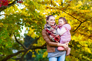 Fototapeta premium mother and her little daughter at beautiful autumn park