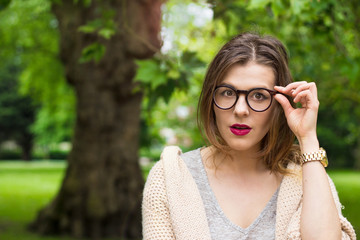 Young female looking shocked in glasses